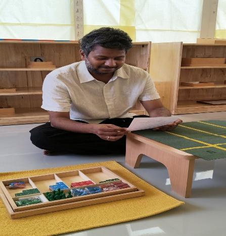 Guide demonstrating authentic Montessori apparatus